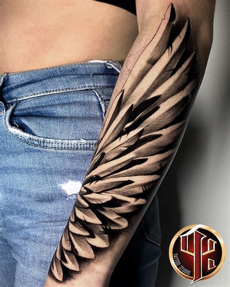 forearm wings tattoo